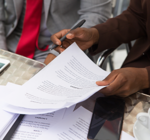 Professional gentlemen signing a document in the office | The Rise of Sustainable Finance | CFOD Hub news and articles